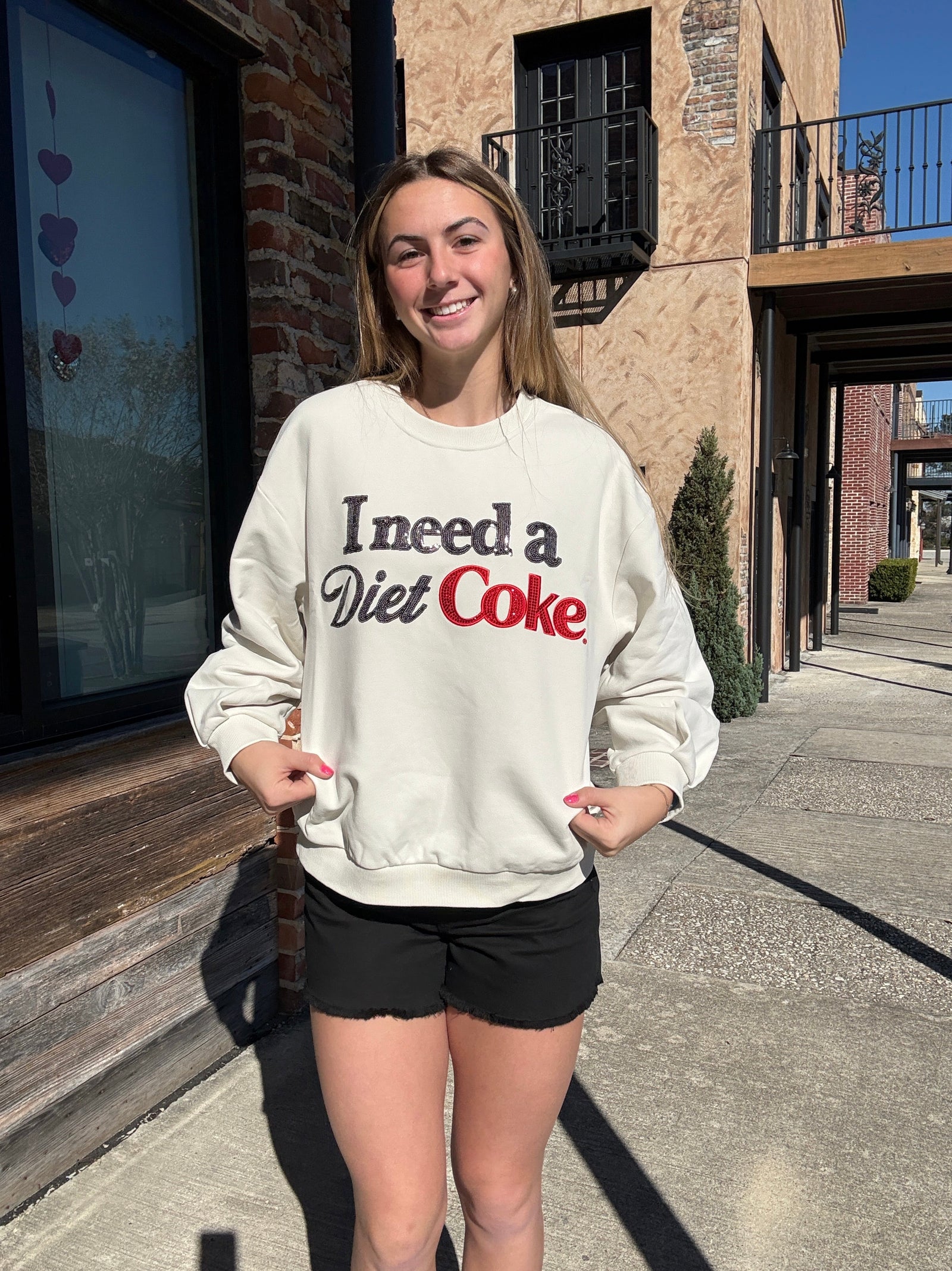 Queen of Sparkles Licensed Beige 'I Need A Diet Coke' Sweatshirt